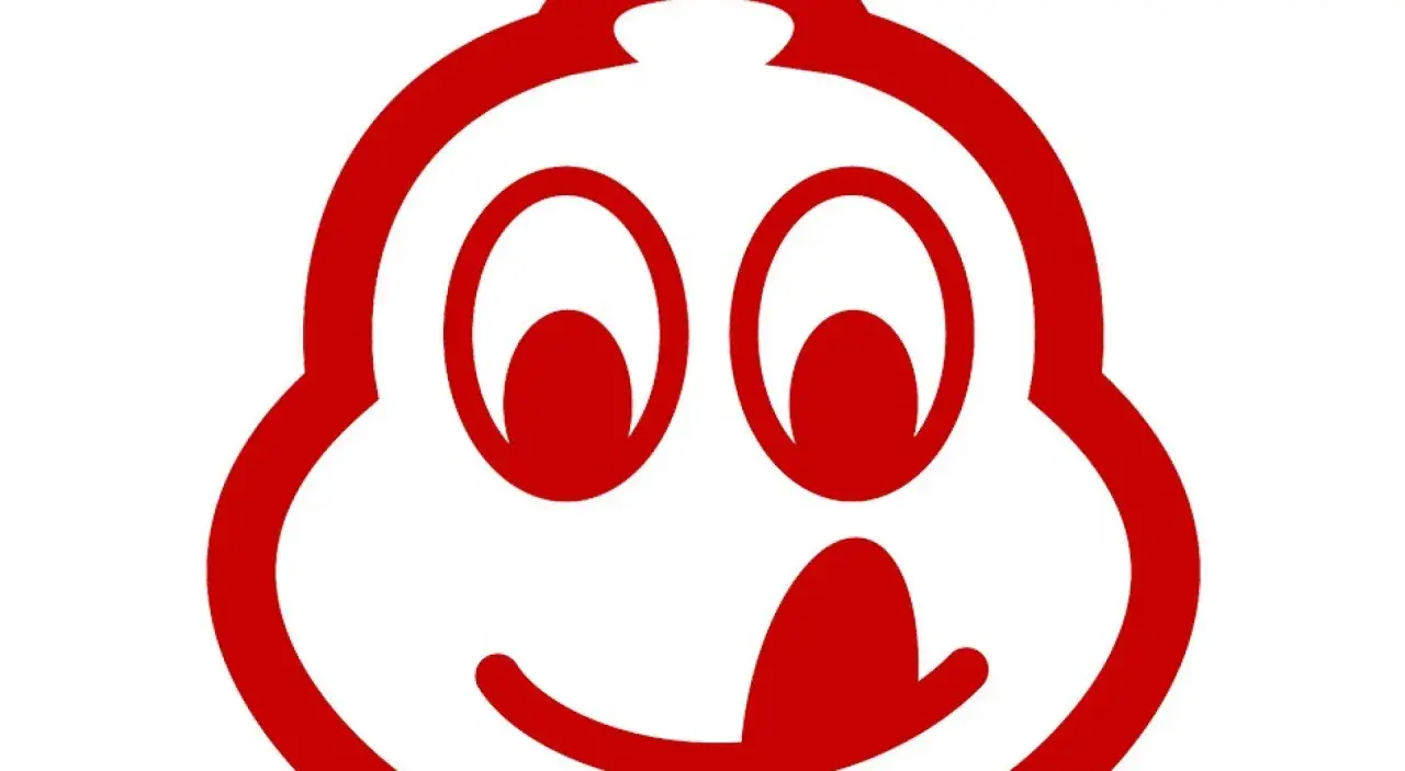 Uśmiechnięta postać z czerwonym logo Michelin, symbolizująca doskonałe jedzenie, które zasługuje na wyróżnienie bib gourmand.